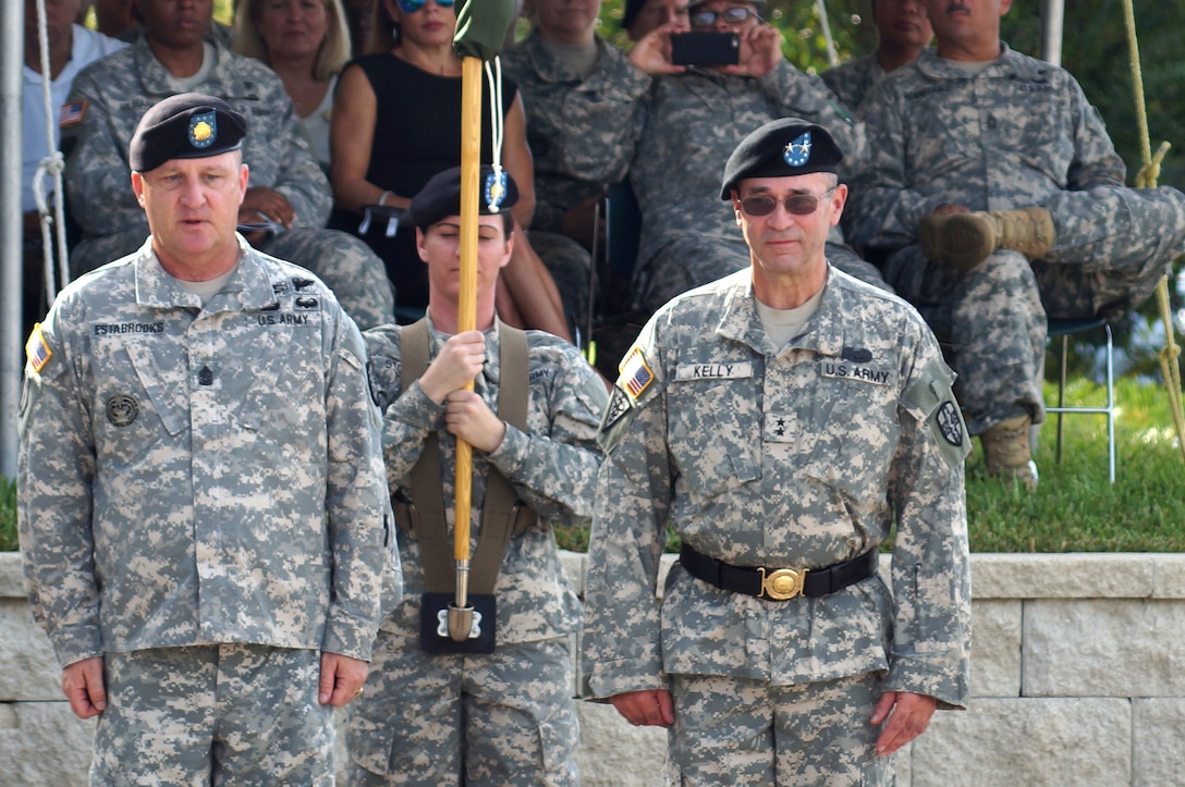 The outgoing command team of the Army Reserve Medical Command, Command Sgt. Maj. Harold P. Estabrooks and Maj. Gen. Bryan R. Kelly, case the command general’s individual flag signifying the end of his command. Estabrooks is scheduled for a tour of duty in Italy and Kelly is retiring after 26 years of dedicated service to the U.S. Army Reserve. He plans to spend more time with his family and continue his civilian career as a clinical psychologist near his hometown of East Sandwich, Mass.