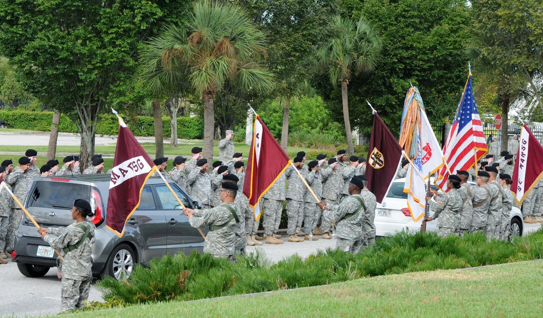 Soldiers of the Army Reserve Medical Command form a line and salute Maj. Gen. Bryan R. Kelly and his family as they departed from the unit’s change of command ceremony Sept. 26, 2015, at the C.W. Bill Young Armed Forces Reserve Center in Pinellas Park, Fla. During the ceremony, Maj. Gen. Mary E. Link assumed command of the unit from Kelly, and Command Sgt. Maj. Marlo V. Cross assumed responsibility from Command Sgt. Maj. Harold P. Estabrooks.