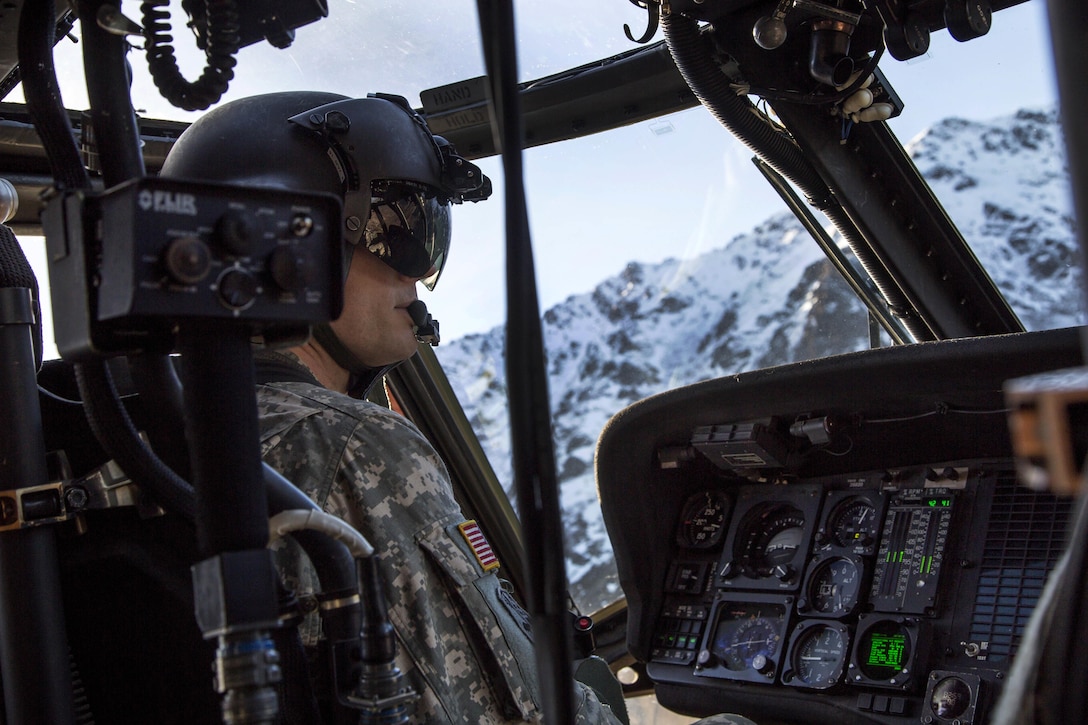 Army Chief Warrant Officer 4 Mark Ward flies his UH-60 Black Hawk helicopter while conducting flight operations over Joint Base Elmendorf-Richardson, Alaska, Oct. 21, 2015. Ward is a pilot assigned to the Alaska Army National Guard's 1st Battalion, 207th Aviation Regiment. U.S. Air Force photo by Alejandro Pena