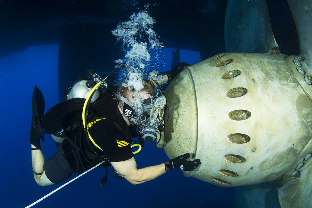 U.S. Navy Petty Officer 2nd Class David Close conducts a ship husbandry dive to inspect running gear in the U.S. 5th Fleet area of responsibility, Oct. 21, 2015. Close is assigned to Commander, Task Group 56.1. U.S. Navy photo by Petty Officer 2nd Class Wyatt Huggett