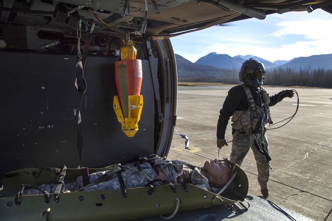 Army Staff Sgt. Kevan Katkus conducts flight procedures after returning to Bryant Army Airfield, Joint Base Elmendorf-Richardson, Alaska, Oct. 21, 2015. Katkus is a crew chiefs assigned to the Alaska Army National Guard's 1st Battalion, 207th Aviation Regiment. U.S. Air Force photo by Alejandro Pena