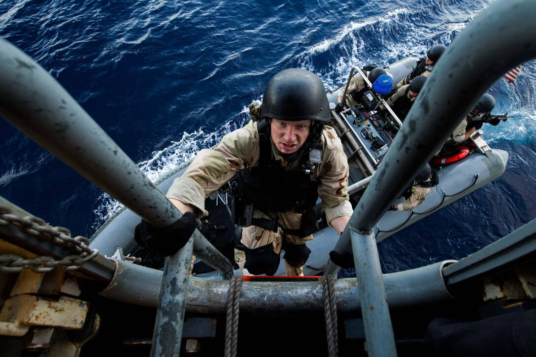 U.S. Navy Petty Officer 3rd Class Sterling Schlapak climbs the pilot ladder to the amphibious transport dock ship USS New Orleans following a visit, board, search and seizure in the Pacific Ocean, Oct. 22, 2015. U.S. Navy photo by Seaman Chelsea D. Daily