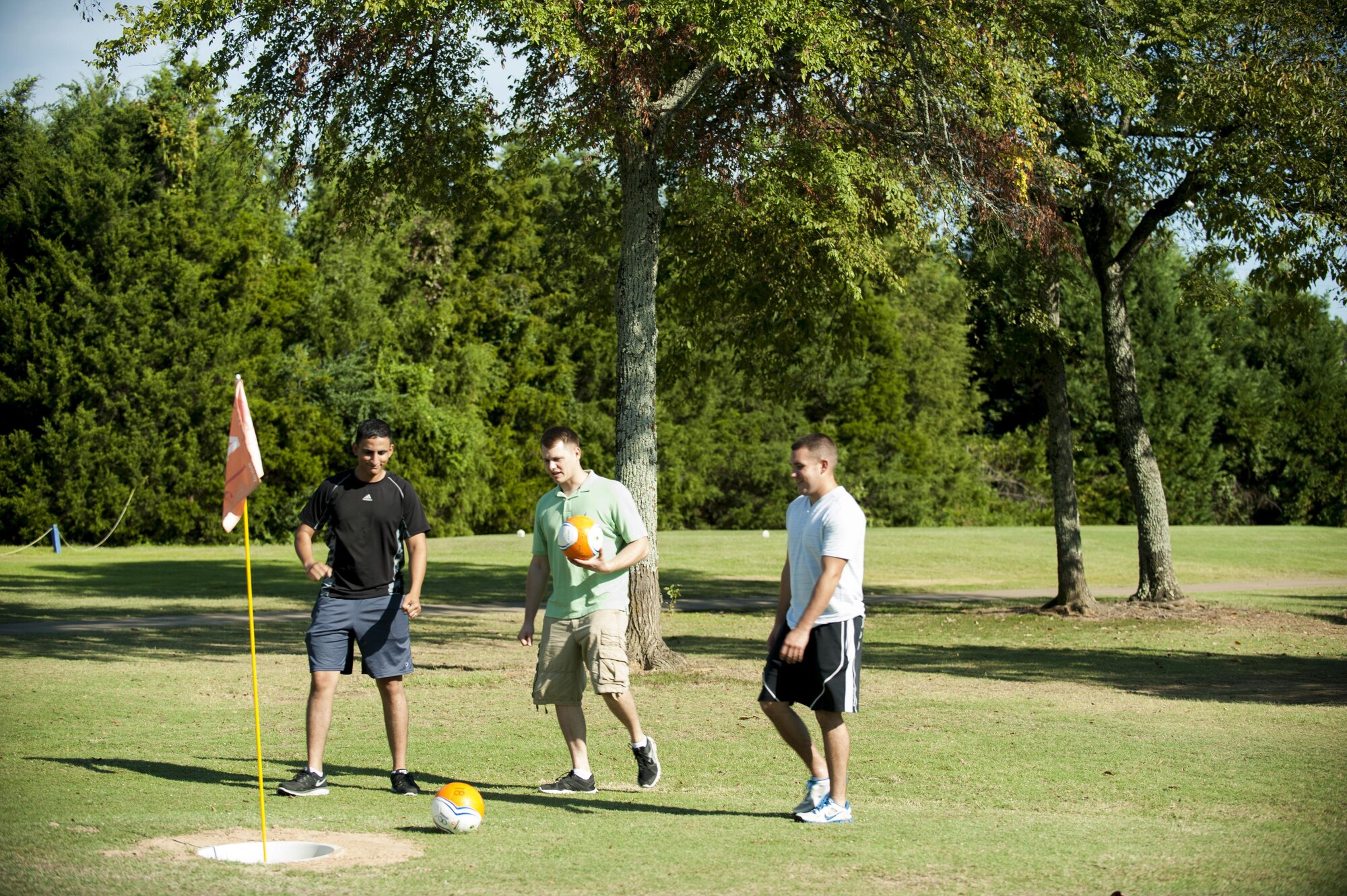 From left, Senior Airman Nesr Mothana, Staff Sgt. Derek Hite and Staff Sgt. John Fox, all with the 19th Civil Engineer Squadron at Little Rock Air Force Base, Arkansas, approach a FootGolf cup on the Deer Run Golf Course. (U.S. Air Force photo/Senior Airman Stephanie Serrano/Released)