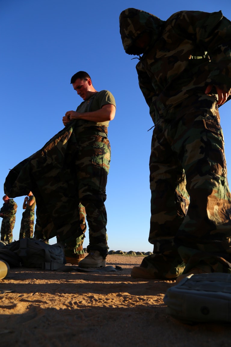 U.S. Marines with the 11th Marine Expeditionary Unit (11th MEU) practice putting on mission oriented protective posture (MOPP) gear as part of chemical, biological, radioactive, and nuclear (CBRN) training during the 11th MEU command element field exercise (CEFEX).  CEFEX marks the 11th MEU’s first field exercise prior to composition as they prepare for WestPac 16-2 deployment. (U.S. Marine Corps photo by Gunnery Sgt. Rome M. Lazarus/Released)