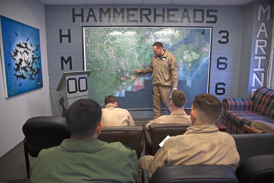Marine Corps Capt. Benjamin Donaldson, center, conducts a preflight brief before rappelling training on Marine Corps Air Station New River, N.C., Oct. 20, 2015. Donaldson is a pilot assigned to Marine Heavy Helicopter Squadron 366. U.S. Marine Corps photo by Lance Cpl. Austin A. Lewis