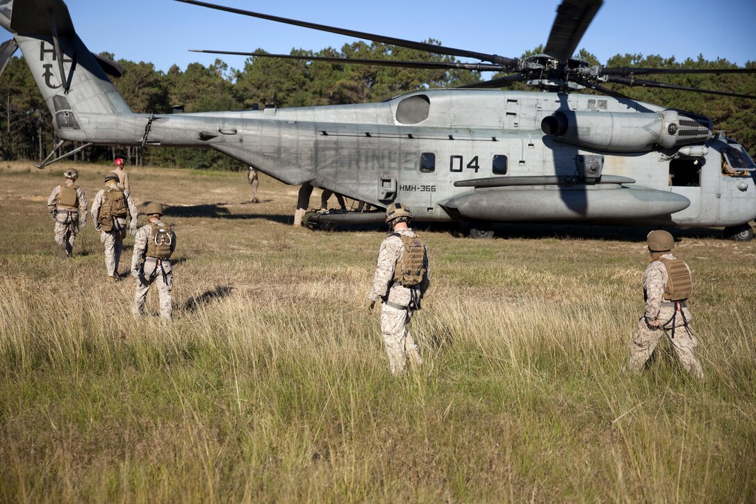 Marines prepare to board a CH-53E Super Stallion helicopter during rappelling training on Marine Corps Base Camp Lejeune, N.C., Oct. 20, 2015. The Marines are assigned to 2nd Reconnaissance Battalion. U.S. Marine Corps photo by Lance Cpl. Austin A. Lewis