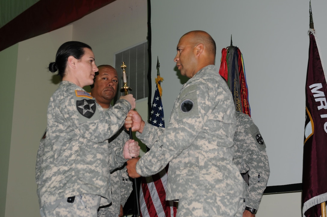 The final step in the change of responsibility ceremony is shown, when Command Sgt. Maj. Juan M. Loera Jr., the new command sergeant major for the Medical Readiness and Training Command, releases the noncommissioned officer sword back to the sword custodian, Staff Sgt. Jamie Stockton, Surgeon Section, AR-MEDCOM, the morning of Sept. 24, 2015, here at the Army Reserve Medical Command Headquarters.