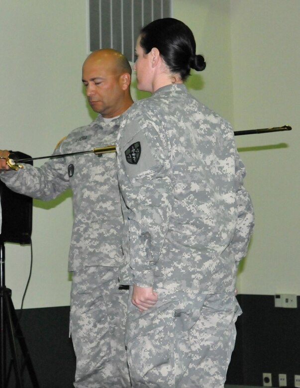 Before relinquishing the noncommissioned officer sword back to the sword custodian, Staff Sgt. Jamie Stockton, Surgeon Section, AR-MEDCOM, the morning of Sept. 24, 2015, here at the Army Reserve Medical Command Headquarters, thereby accepting the duties and responsibilities as the command sergeant major of the Medical Readiness and Training Command, Command Sgt. Maj. Juan M. Loera Jr examines the sword to ensure its "cutting edge" will match his leadership.