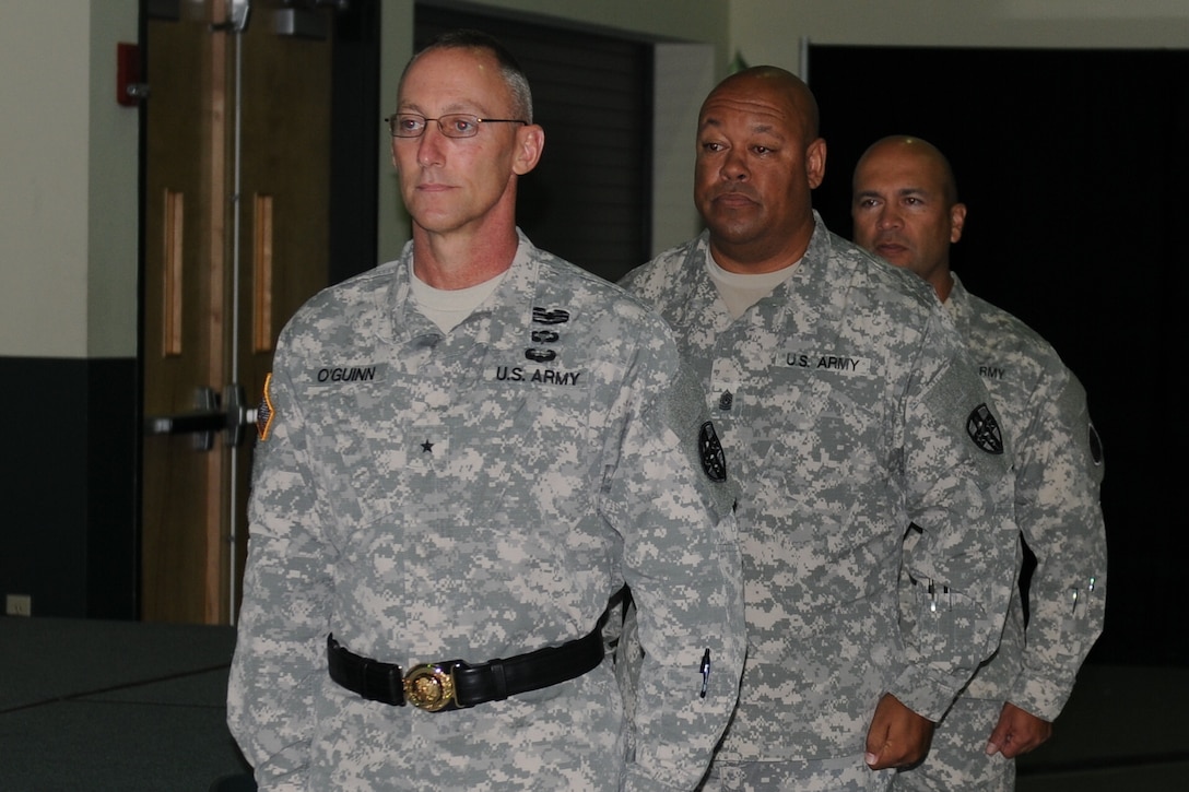 (Forefront) Brig. Gen. Michael C. O’Guinn Command, commanding general of the Medical Readiness and Training Command, (middle) Command Sgt. Maj. Marlo V. Cross, outgoing command sergeant major, and Command Sgt. Maj. Juan M. Loera Jr, incoming command sergeant major, stand ready to begin the change of responsibility ceremony, held at the Army Reserve Medical Command headquarters building in Pinellas Park, Fla., Sept. 24, 2015. Seattle resident Loera’s previous assignment was command sergeant major for the 104th Training Division (Leader Training), Joint Base Lewis-McChord and Cross, a Tempe, Ariz., native, assumes responsibility of ARMEDCOM Sept. 26, 2015. The MRTC is based out of San Antonio.