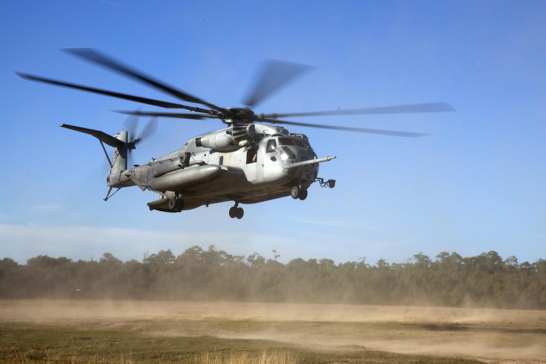 A pilot flies a Marine Corps CH-53E Super Stallion helicopter in a hovering pattern during rappelling training above Marine Corps Base Camp Lejeune, N.C., Oct. 20, 2015. U.S. Marine Corps photo by Lance Cpl. Austin A. Lewis