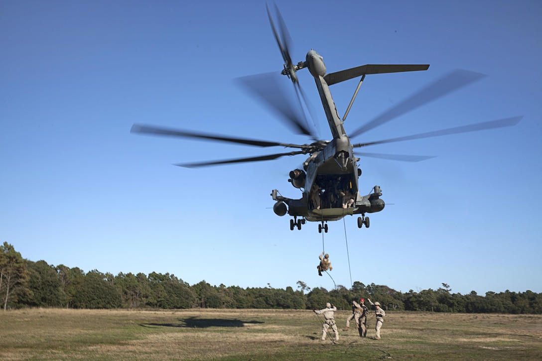 Marines rappel out the back of a CH-53E Super Stallion helicopter during training above Marine Corps Base Camp Lejeune, N.C., Oct. 20, 2015. U.S. Marine Corps photo by Lance Cpl. Austin A. Lewis