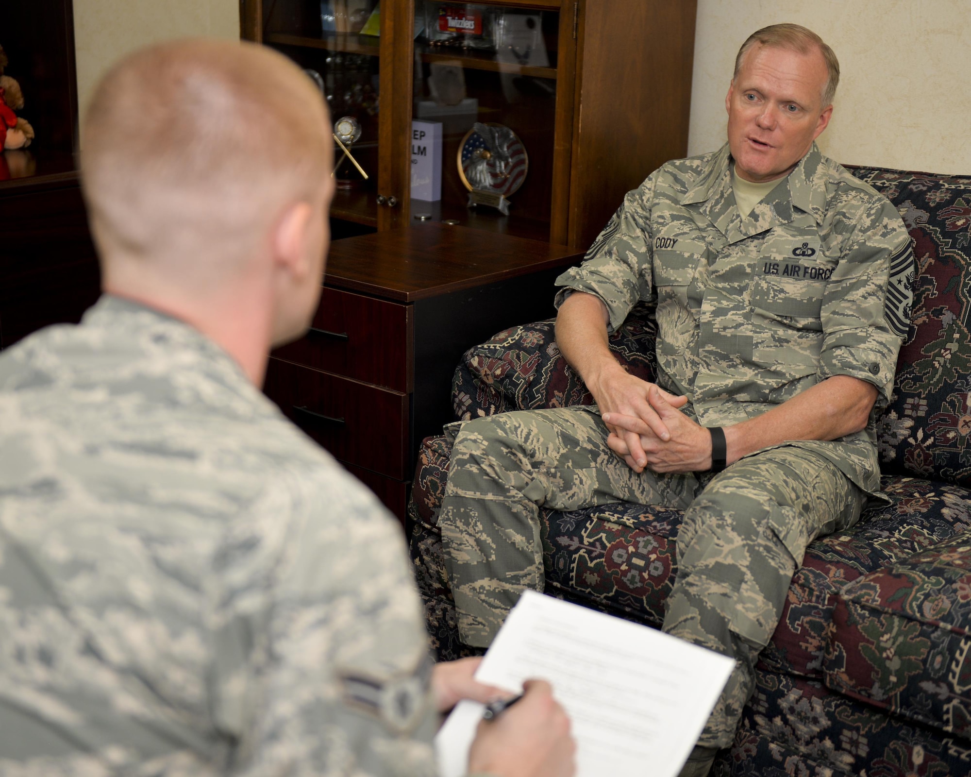 Chief Master Sgt. of the Air Force James A. Cody shares insight about Air Force issues with Airman 1st Class Curt Beach, a 2nd Bomb Wing Public Affairs photojournalist, at Barksdale Air Force Base, La., Oct. 22, 2015. Cody represents the highest enlisted level of leadership, and as such, provides direction for the enlisted force and represents their interests, as appropriate, to the American public and to those in all levels of government. (U.S. Air Force photo/Airman 1st Class Mozer O. Da Cunha) 