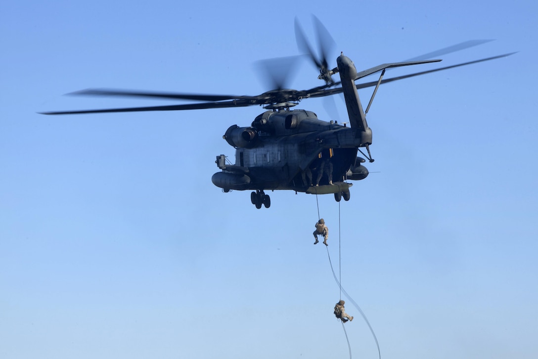 Marines rappel out the back of a CH-53E Super Stallion helicopter during training above Marine Corps Base Camp Lejeune, N.C., Oct. 20, 2015. U.S. Marine Corps photo by Lance Cpl. Austin A. Lewis