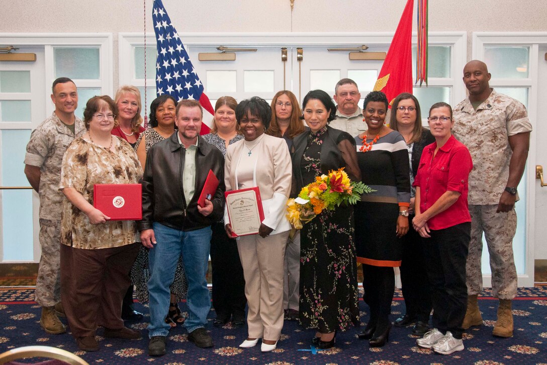 The Civilian Length of Service and Civilians of the Quarter Award Ceremonies were held at The Clubs at Quantico Oct. 22. Base commander Col. Joseph Murray, recognized Kathie Publicover, 35 years of service, June Flowers, 25 years of service, Valerie Gaskin, 20 years of service, Timothy Foltz, 5 years of service, Kathy Dodson, 25 years of service, Tanya Alexander, 10 years of service, Susan Perry, 15 years of service, Monica Tait, 20  years of service, Allan Mitchell, Junior Civilian of the Quarter, Stephanie Thomas, 15 years of service, Monica Curley, 15 years of service, and Kimberly Gale, 15 years of service,  with the help of base sergeant major, Sgt. Maj. Gerald Saunders Jr., Brian Ventura was awarded Senior Civilian of the Quarter, although he was unable to attend the ceremony. 

Each year civilians impact the success of military operations. The Civilian Length of Service Award recognizes dedicated civilians aboard Marine Corps Base Quantico. A senior and junior civilian of the quarter is recognized by a board of senior Quantico staff members for their immeasurable impact on base. The ceremony for fourth quarter awardees is scheduled for December, where the civilian of the year will be recognized in addition to the quarterly winner.