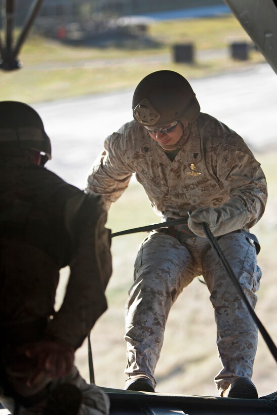 Marine Corps Cpl. Anthony Kassinger prepares to rappel out the back of a CH-53E Super Stallion helicopter during rappelling training above Marine Corps Base Camp Lejeune, N.C., Oct. 20, 2015. Kassinger is assigned to 2nd Reconnaissance Battalion. U.S. Marine Corps photo by Lance Cpl. Austin A. Lewis