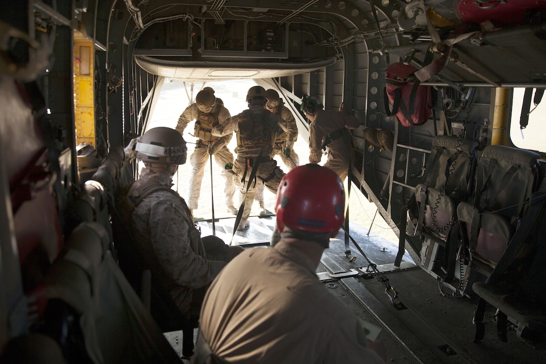 Marines rappel out the back of a CH-53E Super Stallion helicopter during training over Marine Corps Base Camp Lejeune, N.C., Oct. 20, 2015. U.S. Marine Corps photo by Lance Cpl. Austin A. Lewis