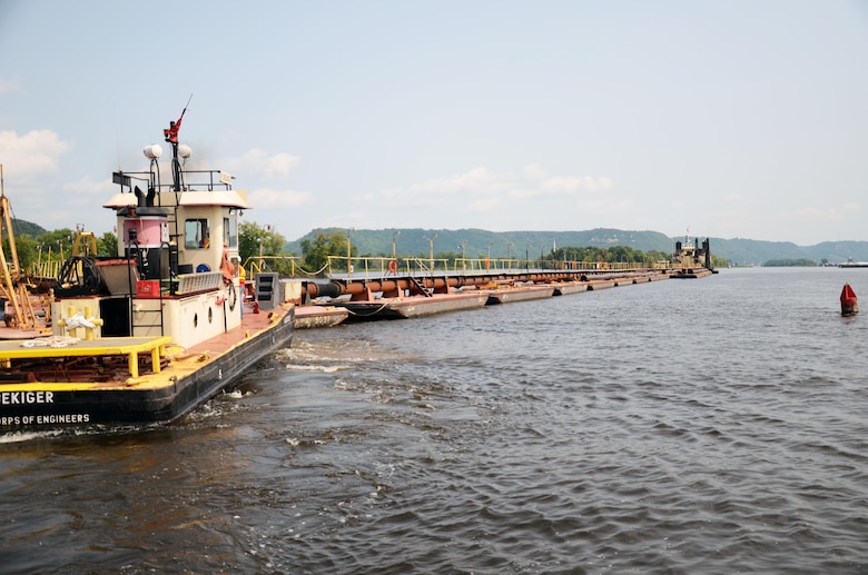 The Dredge Goetz, background, performs emergency dredging in Pool 4 of the Upper Mississippi River during the river's closure in July and August 2014.