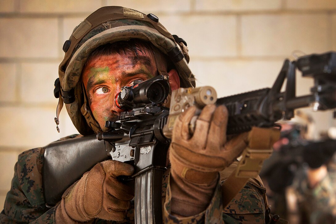 U.S. Marine Corps Lance Cpl. Dakota A. Kaiser engages simulated enemy units during a raid on Combat Town at the Central Training Area in Okinawa, Japan, Oct. 26, 2015. The raid was part of Blue Chromite 2016, a large-scale amphibious exercise. U.S. Marine Corps photo by Lance Cpl. Steven Tran