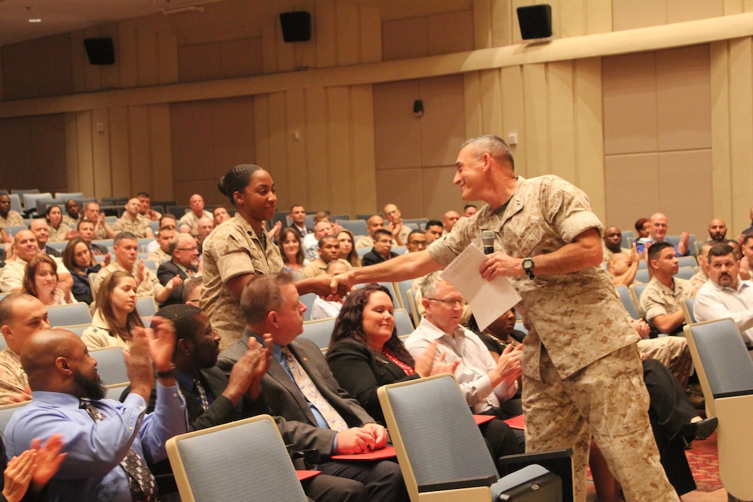 Maj. Gen. James Lukeman, commanding general of Training and Education Command, shakes hands with Sgt. Tamari O'Meally, TECOM NCO of the Quarter runner-up, at the all-hands meeting on Oct. 22.