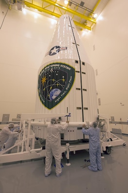 Technicians prepare to close up a Global Positioning System IIF-series satellite within a 4-meter diameter protective payload fairing during final encapsulation Oct. 21 at Cape Canaveral Air Force Station, Fla. GPS IIF satellites provide improved signals that will enhance the precise global positioning, navigation and timing services supporting both the warfighter and the growing civilian needs of our global economy. The Air Force and its mission partners are scheduled to launch GPS IIF-11 aboard a United Launch Alliance Atlas V 401 launch vehicle Oct. 30 from Space Launch Complex 41 at Cape Canaveral AFS, Fla. (United Launch Alliance courtesy photo) 