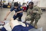 CAMP ZAMA, Japan (Oct. 28, 2015) - Pfc. Sherrad Thomas, assigned to Medical Command, Public Health Command Region-Pacific, learns about CPR and the automated external defibrillator from a Sagamihara City Fire Bureau employee during the fall/winter health and safety fair held Oct. 23 at the Camp Zama Community Activity Center. 