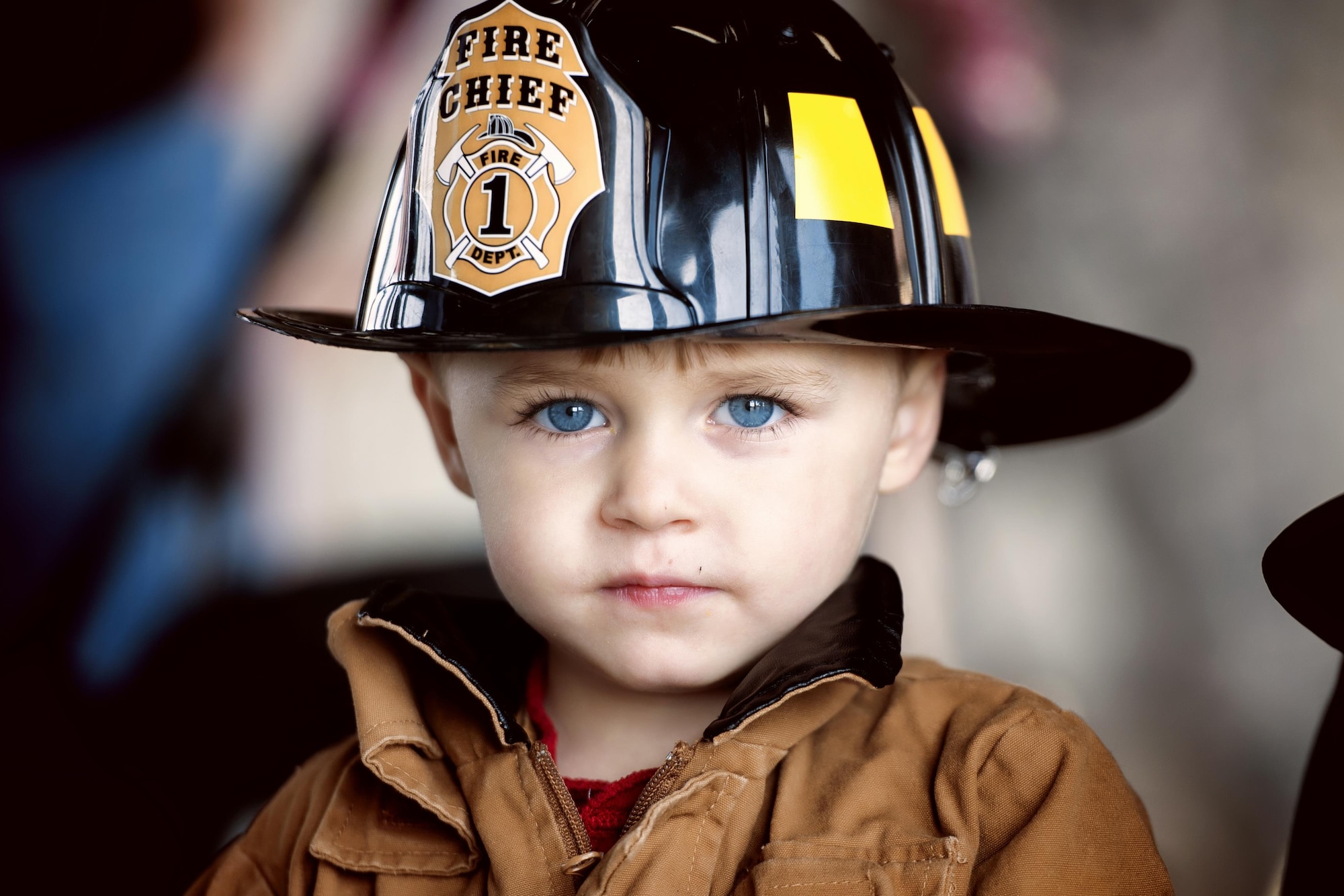 A child tries on a replica firefighting suit during the Yokota fire emergency services 70th anniversary celebration at Yokota Air Base, Japan, Oct. 24, 2015. The celebration offered an opportunity for the Yokota community to have fun while learning important fire prevention tips. (U.S. Air Force photo by Airman 1st Class Delano Scott/Released) 