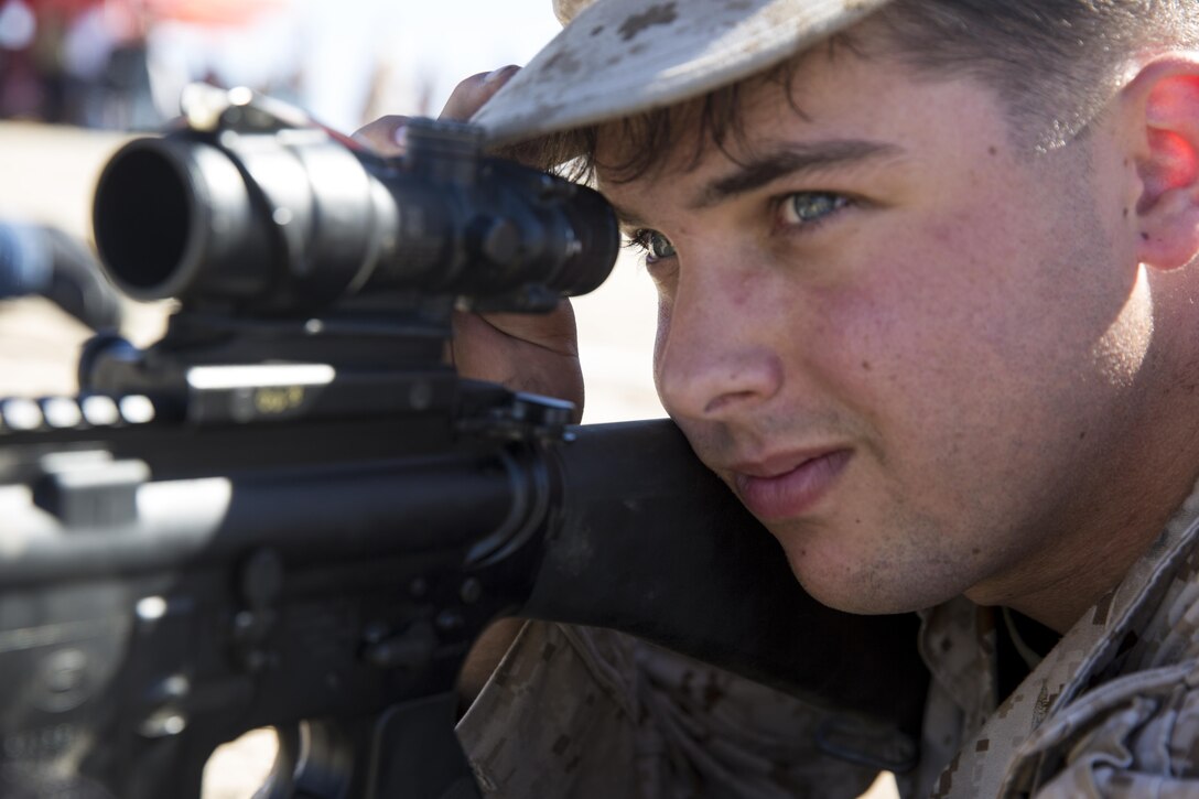 Lance Cpl. Nicholas Piedmonte, an airframe mechanic with Marine Light Helicopter Attack Training Squadron (HMLAT) 303, and an Austin, Texas, native, looks through the RCO of an M16 service rifle during the HMLAT-303 Family Day event aboard Marine Corps Base Camp Pendleton, Calif., Oct. 24. Marines and their family members visited one of Camp Pendleton’s ranges during family to experience firing a service rifle and watch an aerial demonstration. (U.S. Marine Corps photo by Sgt. Lillian Stephens/Released)