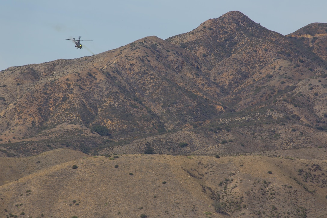 A UH-1Y Huey with Marine Light Helicopter Attack Training Squadron (HMLAT) 303 fires live ammunition during an aerial demonstration aboard Marine Corps Base Camp Pendleton, Calif., Oct. 24. During the demonstration, Marines on the ground communicated with helicopters to perform a multi-phase, live-fire event. (U.S. Marine Corps photo by Sgt. Lillian Stephens/Released)