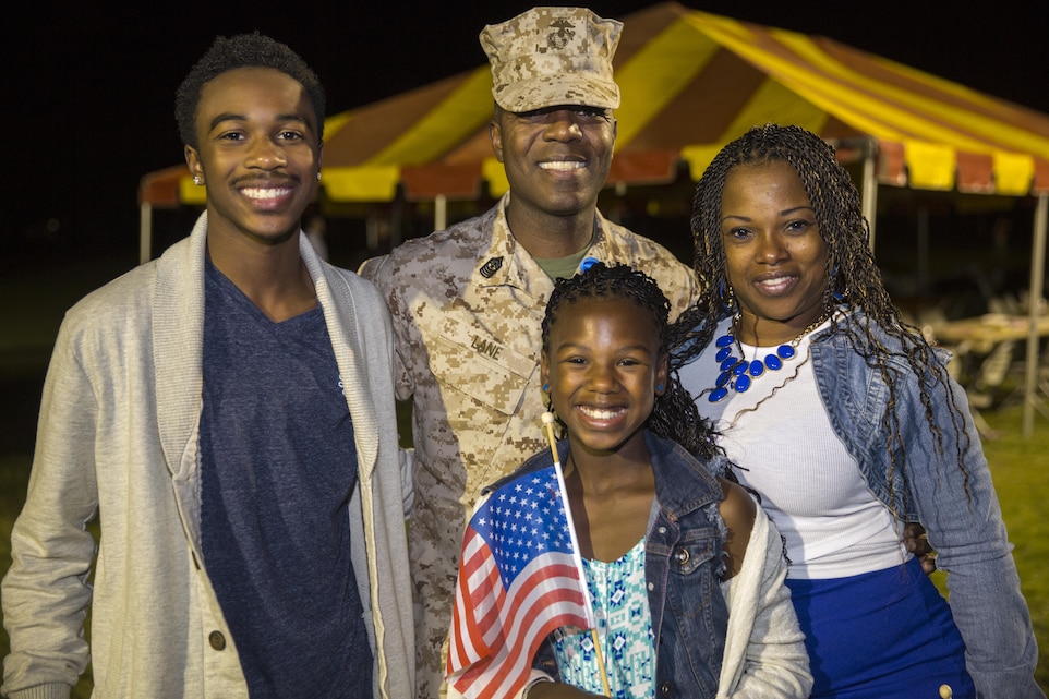 Sgt. Maj. Rodney L. Lane, regimental sergeant major, 7th Marine Regiment, embraces his family during the regiment’s homecoming at Lance Cpl. Torrey L. Gray Field, Oct. 23, 2015. ‘Magnificent Seventh’ deployed as part of Special Purpose Marine Air Ground Task Force – Crisis Response – Central Command 15.2. (Official Marine Corps photo by Lance Cpl. Levi Schultz/Released)