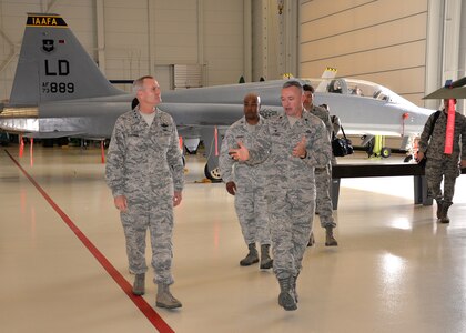 Lt. Gen. Darryl Roberson, commander, Air Education and Training Command, tours a hanger at the 318th Training Squadron from Brig. Gen. Trent Edwards, 37th Training Wing commander, and Lt. Col. William Latimer, 318th TRS commander, Oct. 22, 2015, at Joint Base San Antonio-Lackland, Texas. The 318th TRS, which belongs to the Inter American Air Forces Academy, provides Air Force technical training courses to South American partner nation service members. The courses, taught by U.S. Airmen, are taught completely in Spanish. (