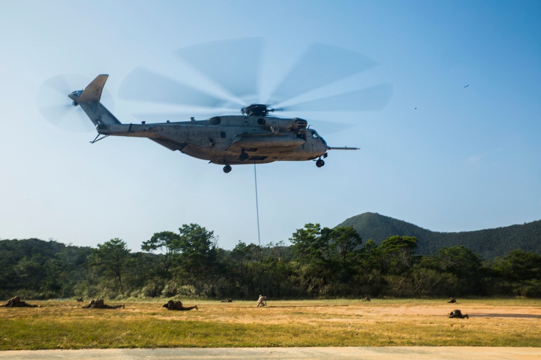 Military police Marines conduct fast roping out of a CH-53E Super Stallion in support of Blue Chromite 16 in the Central Training Area, Okinawa, Japan, Oct. 28, 2015. The Marines, with the help of a military working dog, were tasked with tracking down the pilot and two downed aircrew members on a simulated downed aircraft. Blue Chromite is a large-scale amphibious exercise that draws primarily from III Marine Expeditionary Force’s training resources on Okinawa. The location of the training allows participating units to maintain a forward-deployed posture and eliminates the cost of traveling to train. The Marines are with 3rd Law Enforcement Battalion, III Marine Expeditionary Force Headquarters Group, III MEF. The CH-53E Super Stallion is with Marine Heavy Helicopter Squadron 462, Marine Aircraft Group 16, 3rd Marine Aircraft Wing, I MEF.