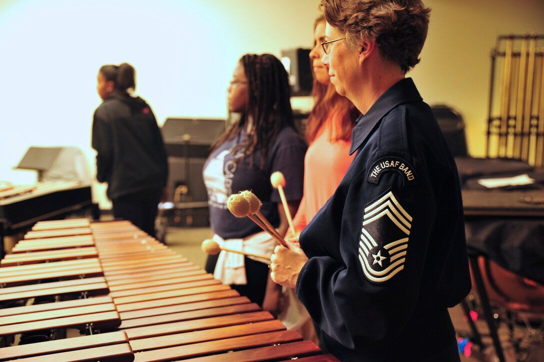 Chief Master Sgt. Erica Montgomery works with students during a clinic at Everett High School in Everett, Massachusetts while on tour with the Concert Band and Singing Sergeants for their Fall 2015 tour. The clinic was part of the Band's AIM program: Advancing Innovation through Music. (U.S. Air Force photo/released)