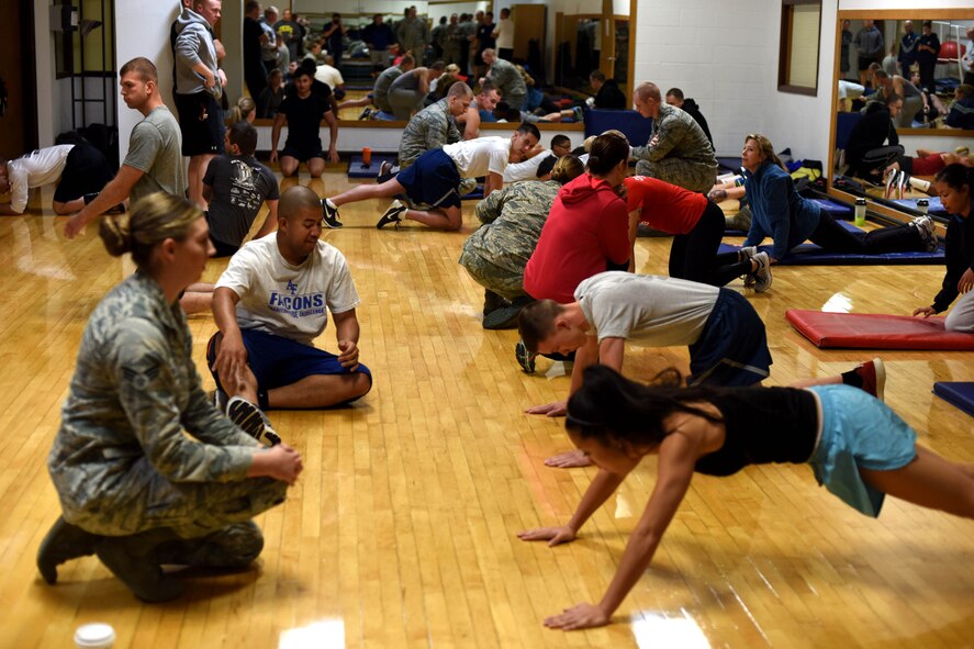 Participants of the Malmstrom Air Force Base physical training competition complete the pushup portion of the event at the Malmstrom Fitness Center Oct. 27, 2015. Performance techniques and the scoring system were based on guidance contained in the Air Force fitness instruction. (U.S. Air Force photo/Airman Collin Schmidt) 
