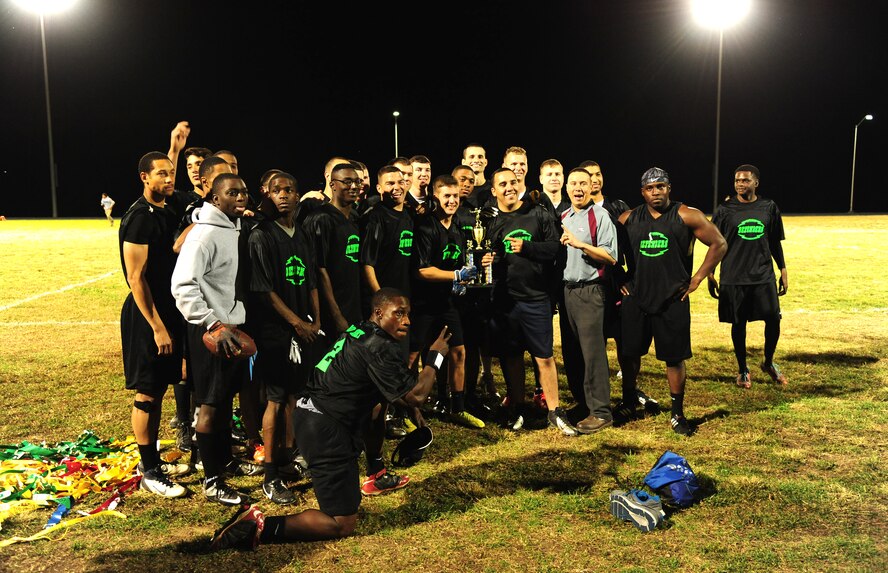 Members of the 509th Security Forces Squadron (SFS) pose with the intramural flag-football championship trophy at Whiteman Air Force Base, Mo., Oct. 26, 2015. The 509th SFS was awarded the trophy after winning the game with a score of 32-24. (U.S. Air Force photo by Senior Airman Joel Pfiester/Released)