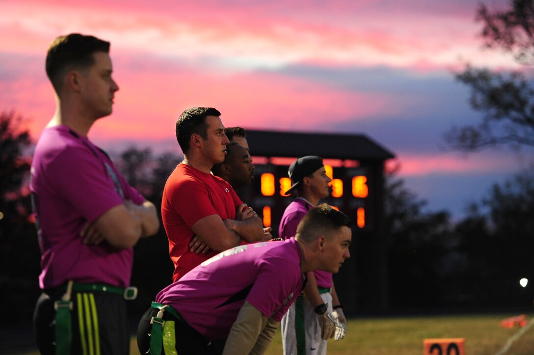 Members of the 509th Operations Support Squadron (OSS) watch the action on the field from the sideline during the intramural flag-football championship game at Whiteman Air Force Base, Mo., Oct. 26, 2015 The 509th OSS faced off against the 509th Security Forces Squadron (SFS). The 509th SFS would go on to defeat the 509th OSS with a score of 32-24. (U.S. Air Force photo by Senior Airman Joel Pfiester/Released)
