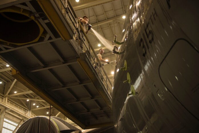 (From left to right) 437th Maintenance Squadron aircraft structural maintainers, A1C Matthew Hoofnagle and A1C Micheal Mooney, wash the C-17 Globemaster III in building 515 at Joint Base Charleston – Air Base, S.C., on Oct. 15, 2015. Once completed, the next task is to repaint the sanded parts of the C-17. (U.S. Air Force photo/Airman 1st Class Thomas T. Charlton)