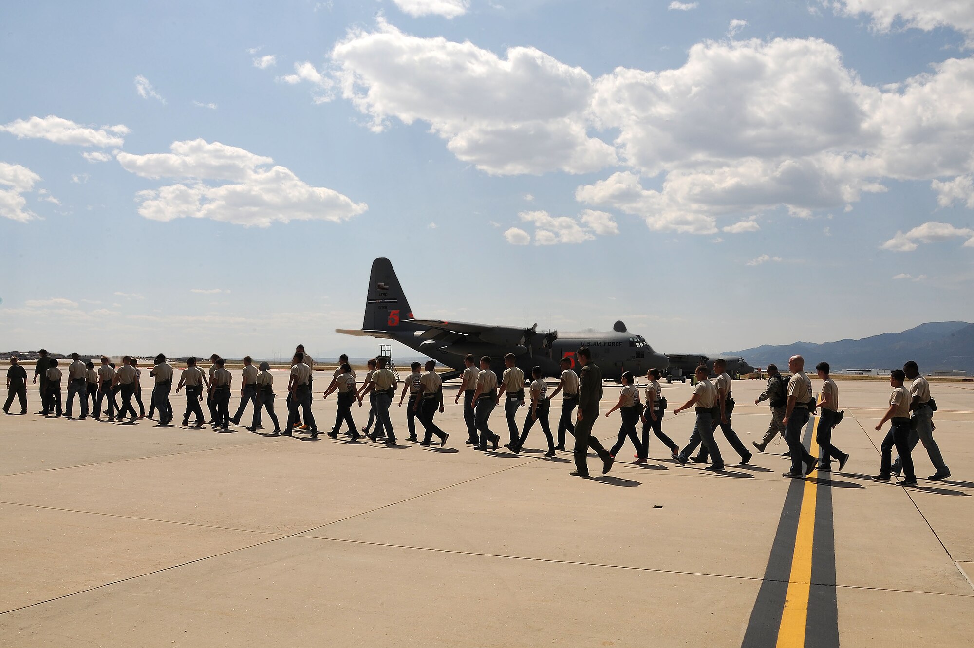 PETERSON AIR FORCE BASE, Colo. – Trainees with the 302nd Airlift Wing and 310th Space WingDevelopment and Training FlightAir Force Reserve Command’s 302nd Airlift Wing and 310th Space Wing trainees with the Development and Training Flight march to a C-130 Hercules aircraft for a tour Sept. 13, 2015 here. The focus of D&TF is to prepare trainees for basic training, technical school, and an Air Force Reserve career. (U.S. Air Force photo/Senior Airman Amber Sorsek)