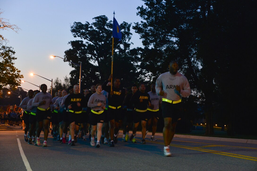 U.S. Army Sgt. Maj. James H. Jackson, 733rd Mission Support Group command sergeant major, leads Soldiers in a Domestic Violence Awareness Month run at Fort Eustis, Va., Oct. 23, 2015.  Leaders from across the installation participated in the event, emphasizing the importance of awareness and available resources for military and community members. (U.S. Air Force photo by Staff Sgt. Natasha Stannard/Released)