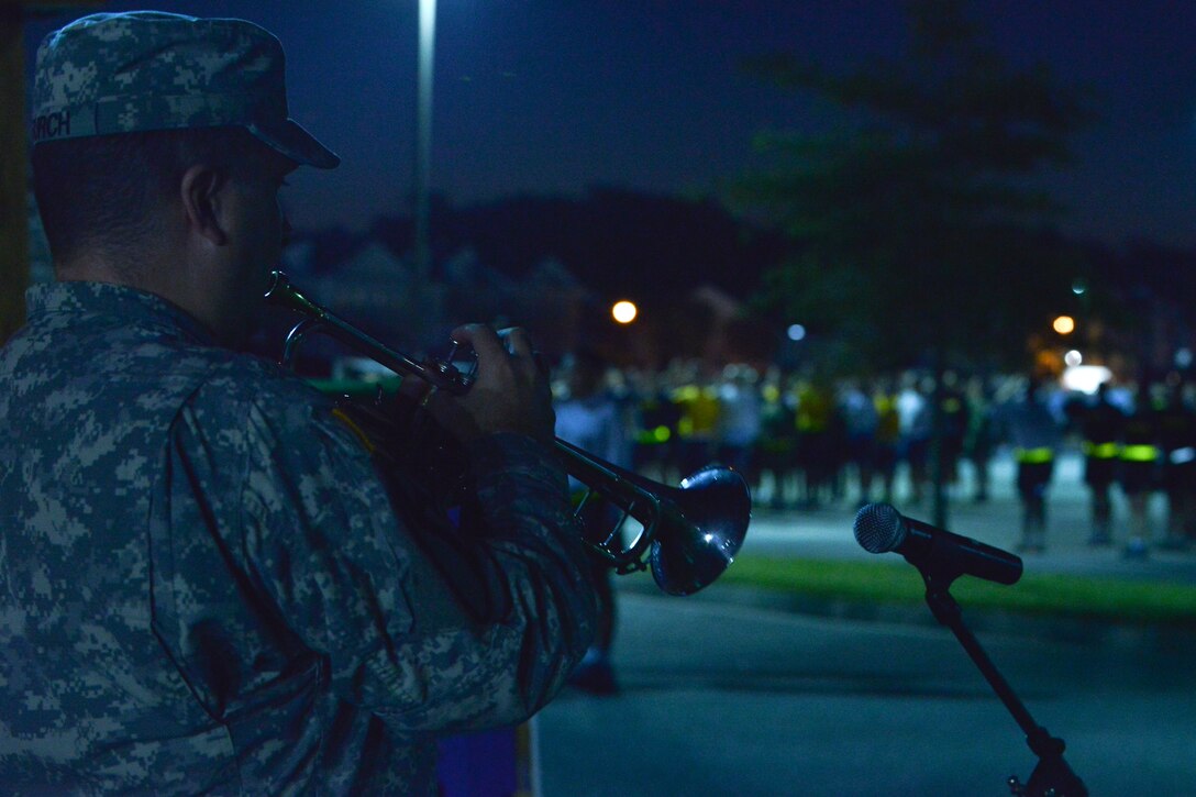 A U.S. Army Soldier plays the bugle to signify the beginning of a Domestic Violence Awareness Month run at Fort Eustis, Va., Oct. 23, 2015. The run was one of several events held to increase domestic violence awareness during the observance month. (U.S. Air Force photo by Staff Sgt. Natasha Stannard/Released)