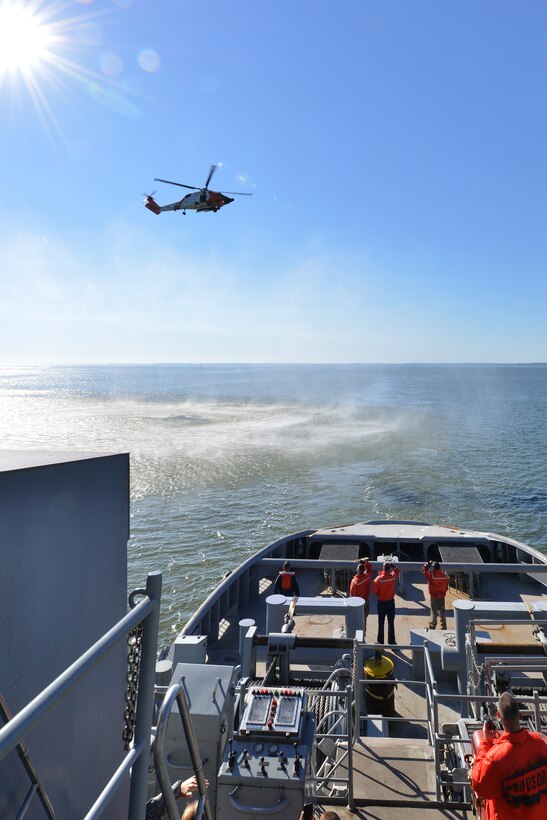 Members of the U.S. Coast Guard make their way to the 73rd Transportation Company U.S. Army tugboat MG Winfield Scott to participate in a joint casualty evacuation exercise at Fort Eustis, Va., Oct. 21, 2015. The exercise involved teaching and exchanging techniques in hoisting a patient from a vessel to a helicopter for immediate medical transport while at sea. (U.S. Air Force photo by Staff Sgt. Natasha Stannard/Released)