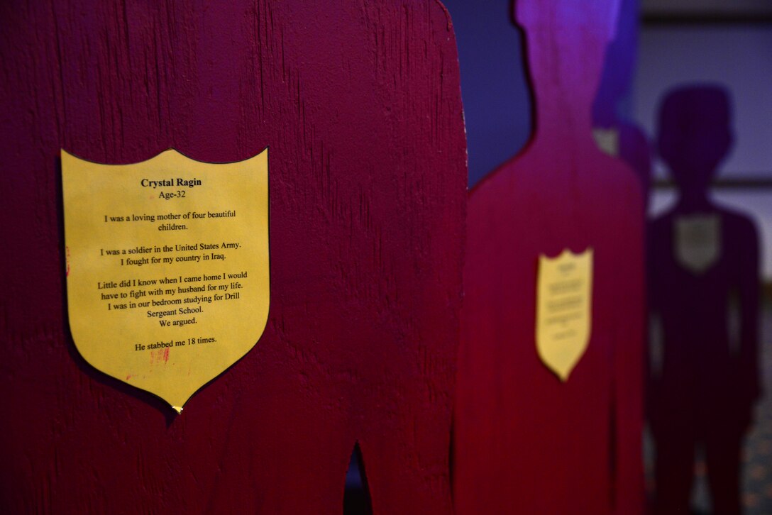 A Silent Witness exhibit representing the Ragin family, local victims of domestic violence, is displayed during a Domestic Violence Awareness Month briefing at Fort Eustis, Va., Oct. 21, 2015. According to The Silent Witness National Initiative, the program provides hope, help and healing for the victims and violators of domestic violence by sharing their stories. (U.S. Air Force photo by Senior Airman Aubrey White/Released)