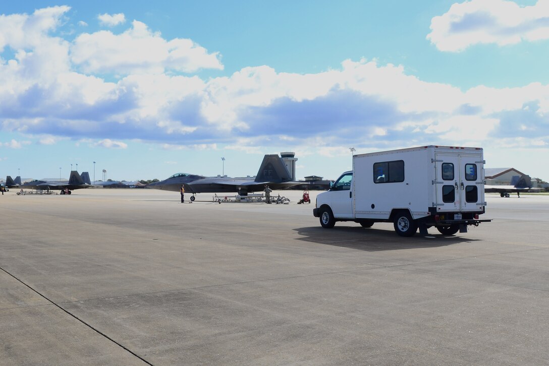 F-22 Raptors await fuel at Langley Air Force Base, Va., Oct. 19, 2015. The 633rd Logistics Readiness Squadron fuel technicians used pantographs to fuel the aircraft from an underground supply during hot pits operations. (U.S. Air Force photo by Senior Airman Kimberly Nagle/Released) 