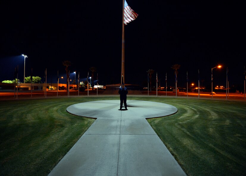 An Airman stands at parade rest in front of Luke Air Force Base's wing headquarters in support of POW/MIA Day at Luke Air Force Base, Ariz., Sept. 18, 2015. This annual event honors missing service members and their families, and highlights the government’s commitment to account for them. (U.S. Air Force photo by Senior Airman Devante Williams)