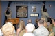 Staff Sgt. Alexena Simien, 56th Operations Support Squadron air traffic controller, and Senior Airman Samuel Bricker, 56th OSS air traffic controller, unveil Senior Airman Scott Hill’s memorial wall during a dedication ceremony at Luke Air Force Base, Arizona, Oct. 26, 2015. Hill lost his battle with cancer and passed away May 18, 2014. The ceremony also retired Hill’s air traffic controller initials: HI. The initials are a special identifier for controllers and HI will be Hill’s at Luke forever. (U.S. Air Force photo by Senior Airman James Hensley)