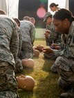 A 5th Medical Group Global Strike Challenge team performs CPR on a dummy during a GSC competition at Minot Air Force Base, N.D., Oct. 19, 2015. The 5th MDG had six teams that competed against each other. (U.S. Air Force photo/Airman 1st Class Sahara L. Fales)