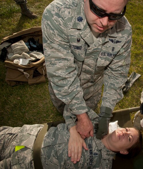 Lt. Col. Scott Tonko, 5th Medical Group Global Strike Challenge exec team member, practices self-aid buddy care on his teammate during a Global Strike Challenge competition at Minot Air Force Base, N.D., Oct. 19, 2015. This was the first year that members of the 5th Medical Group participated in GSC. (U.S. Air Force photo/Airman 1st Class Sahara L. Fales)