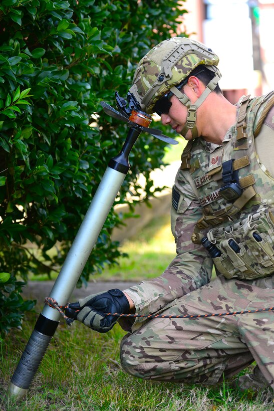 U.S. Air Force Tech. Sgt. Charles Shewmaker, 633rd Civil Engineer Squadron Explosive Ordnance Disposal team lead, tightens a rope around a simulated explosive device at Langley Air Force Base, Va., Oct. 14, 2015. The EOD technicians at Joint Base Langley-Eustis, Va., are responsible for any potential explosive ordnance threats at both installations. (U.S. Air Force photo by Senior Airman Kimberly Nagle/Released) 
 
