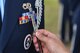 Staff Sgt. April Spilde, U.S. Air Force Honor Guard mobile training team instructor, measures spacing between ribbons and an Air Force Specialty Code badge on the uniform of Senior Airman Michael Oliver, Eglin Air Force Base Honor Guard member, during a uniform inspection at Hurlburt Field, Fla., Oct. 19. The mobile training team traveled from Bolling AFB, Washington, D.C., to train 15 base honor guard members from Hurlburt, Eglin and Tyndall AFB. The seven-day course totaled 80 hours of instruction and focused on standardized flag presentation, firing party and pallbearer techniques. (U.S. Air Force photo by Senior Airman Jeff Parkinson) 
