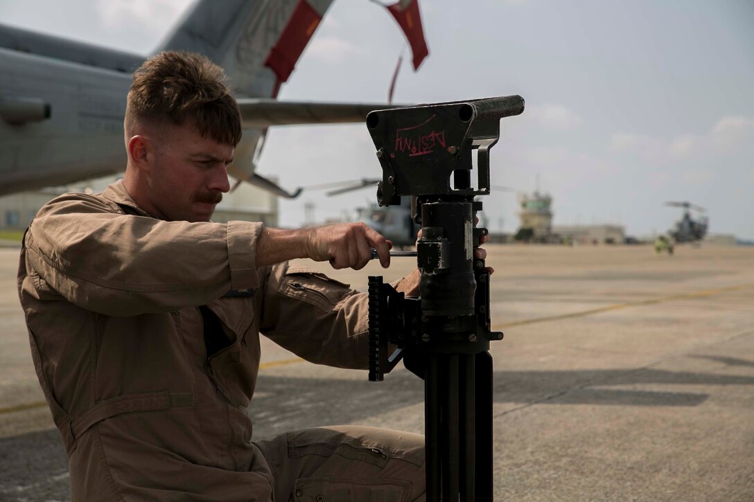 Sgt. Brandon Jackson assembles a Dillon M134 Gatling Gun before departing for a mission to recover a simulated downed aircraft, Oct. 28, 2015, during Blue Chromite 16, at Marine Corps Air Station Futenma, Okinawa, Japan. The mission, which included assets from Marine Air Group 36, also included members of 3rd Law Enforcement Battalion, who recovered personnel with assistance of military working dogs. Blue Chromite is a large-scale amphibious exercise that draws primarily from III Marine Expeditionary Force’s training resources on Okinawa. The location of the training allows participating units to maintain a forward-deployed posture and eliminates the cost of traveling to train. Jackson is from Fort Collins, Colo., and a Bell UH-1Y Venom airframe mechanic with MAG 29, HMLA 269, 2nd Marine Aircraft Wing, II Marine Expeditionary Force, currently attached to 1st MAW, III MEF. (U.S. Marine Corps Photo by Cpl. Devon Tindle/Released)