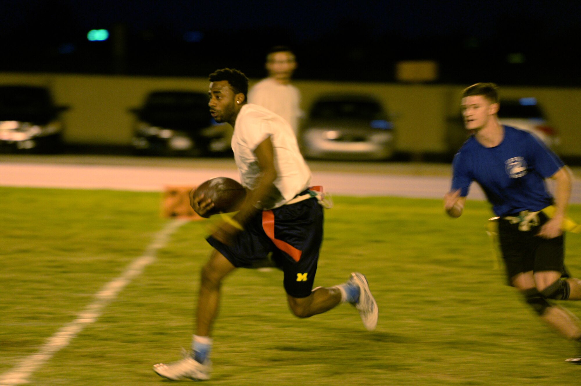 Chris Hamilton, Army and Air Force Exchange Service wide receiver, runs the ball downfield, Oct. 26, 2015, at Luke Air Force Base. The AAFES team beat the 56th Security Forces Squadron team to advance to the second round of the championship bracket. (U.S. Air Force photo by Airman 1st Class Ridge Shan)